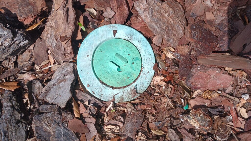 What is this green disk in the ground around my house?