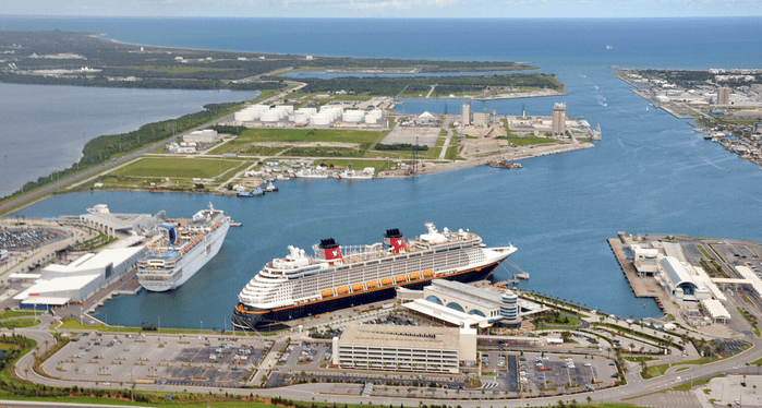 Aerial view of Port Canaveral with cruise ships and industrial facilities.