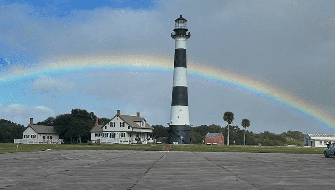 Cape Canaveral Lighthouse with a rainbow over the historical buildings.