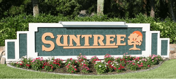 Suntree Community Entrance Sign; A large, green and gold sign for the Suntree community, with flowers at the base.