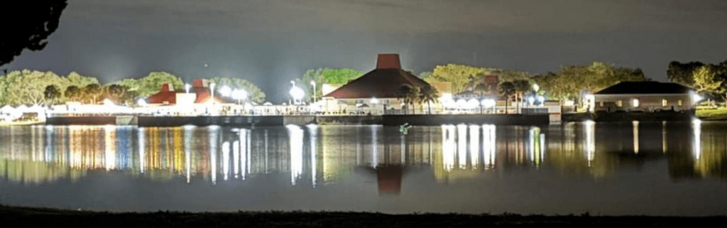 A nighttime view of the Barefoot Bay community across the lake. Barefoot Bay-Micco Pest Control